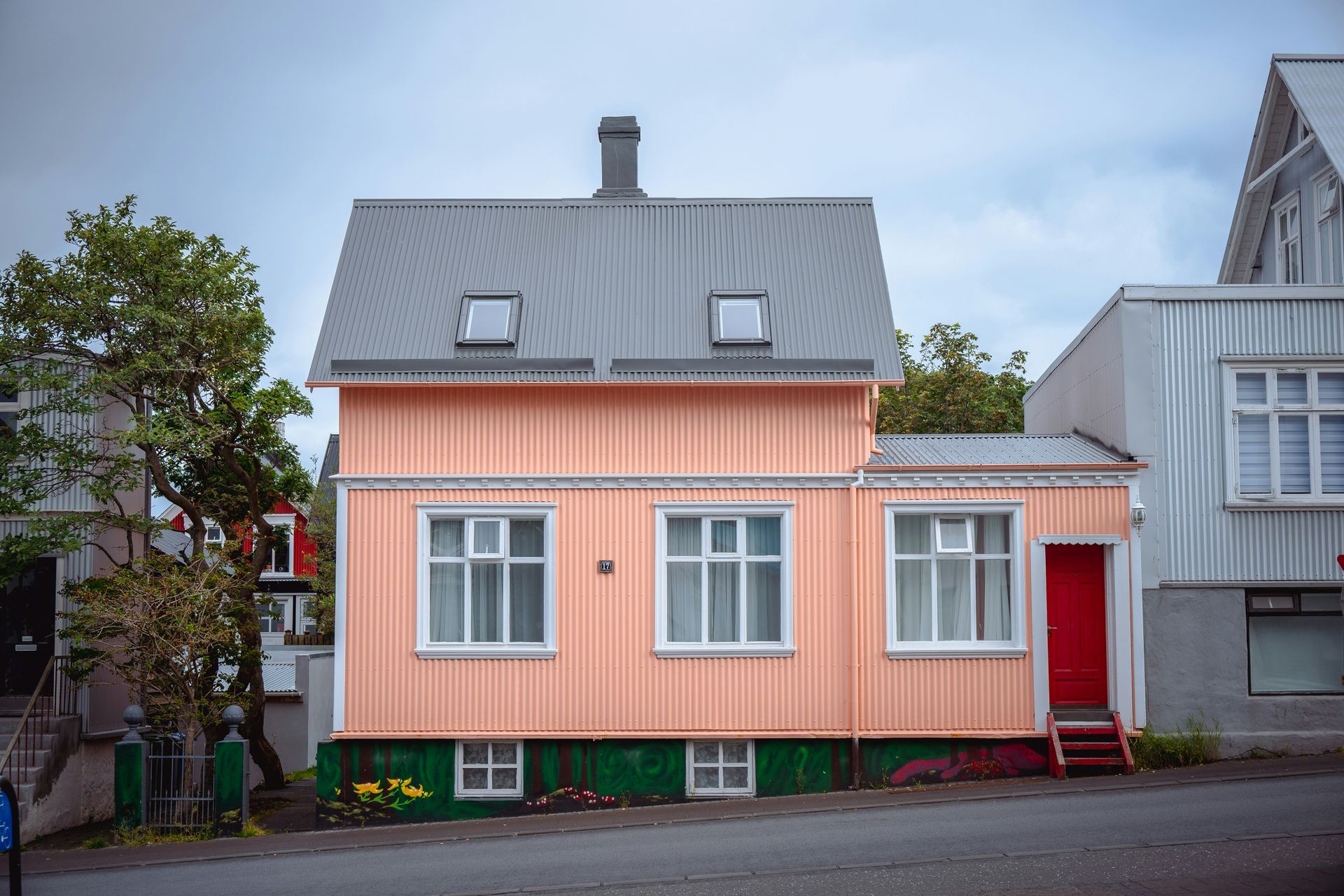 A colorful house stands on a city street
